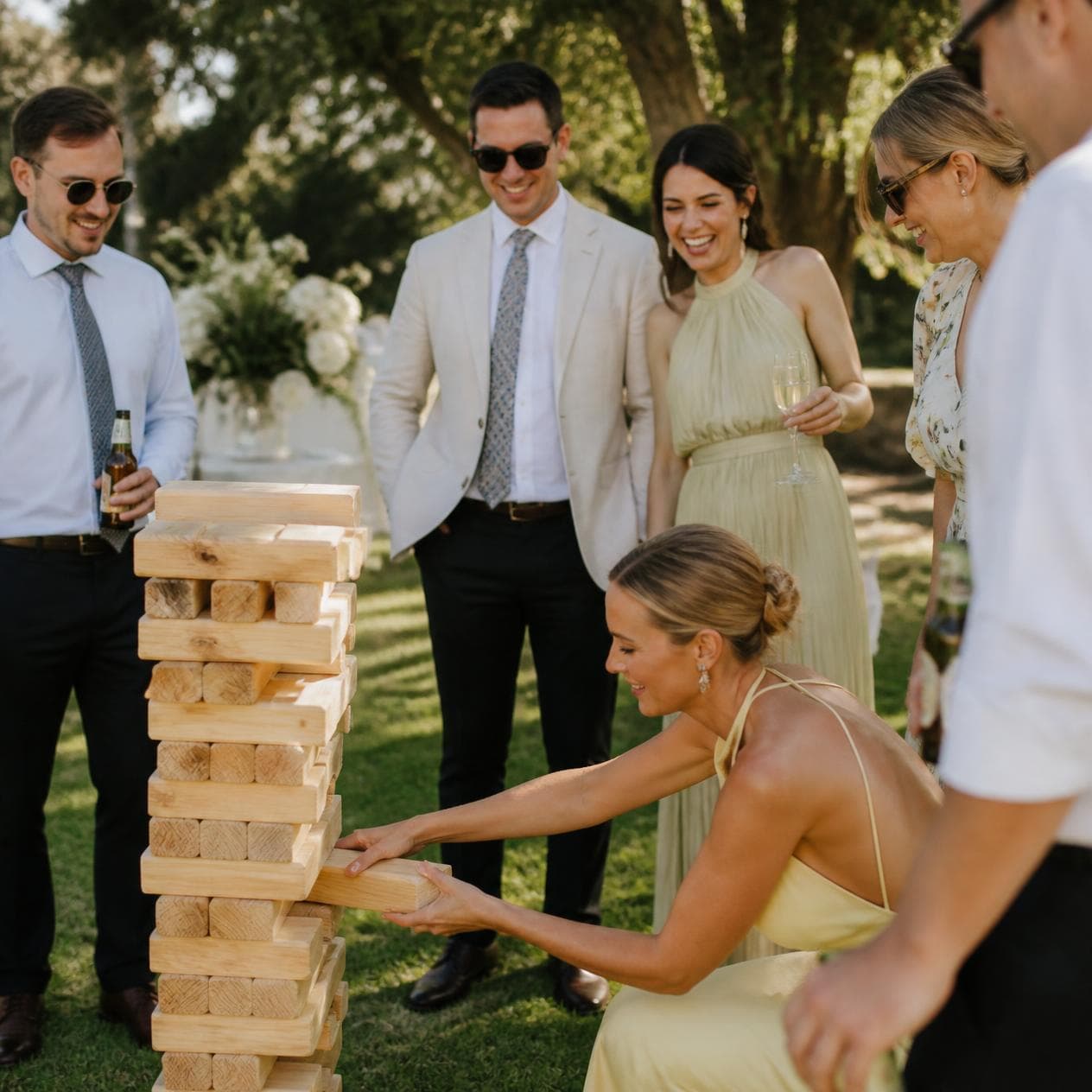 LoveLark Events giant Jenga hire — guests playing on a wedding lawn